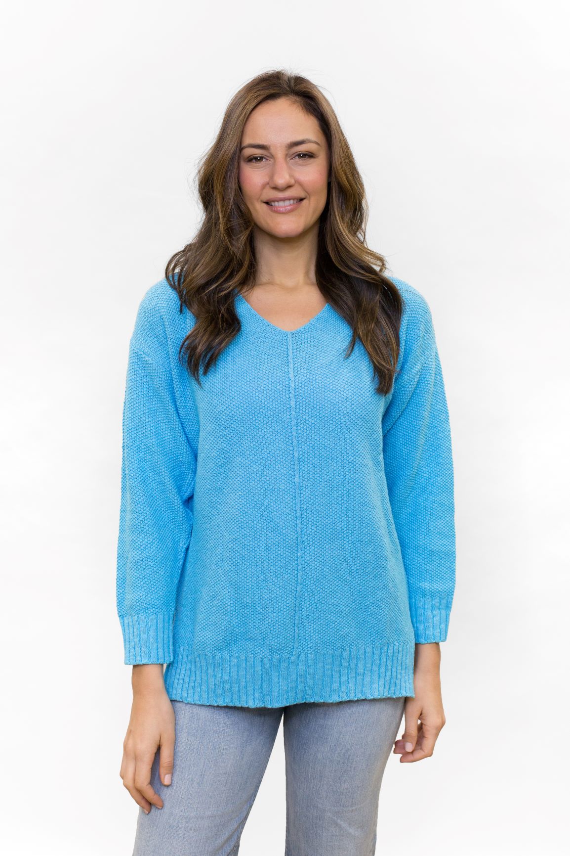 100% cotton slub seed stitch sweater by Avalin. In color Turquoise with long sleeves, v-neck, center seam, ribbed cuffs and ribbed straight hem with side slits. Falls just below mid hip.  Made in USA.