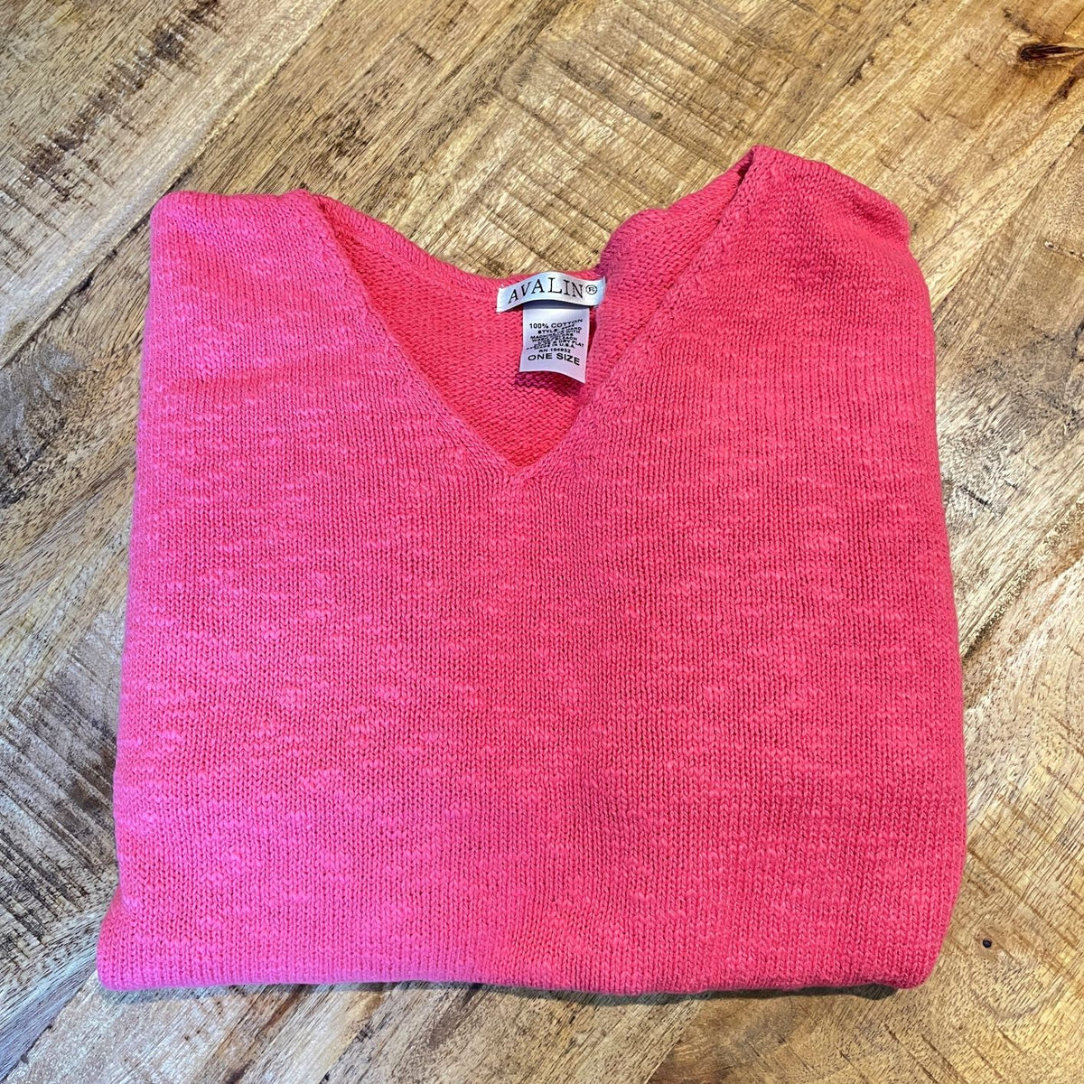 100% cotton slub sweater by Avalin. In color Coral with long sleeves, v-neck, straight hem with ribbed edges. Semi-crop style falls just below the belt. Made in USA.
