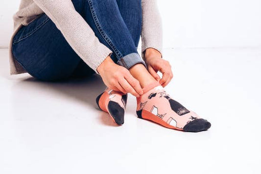 Ankle sock that says Wine Down on the bottom. These rose color socks have wine bottle and wine glasses on them. Made of 58% Cotton, 22% Nylon, 16% Poly, 4% Spandex these are a nicely made, comfortable pair of socks.