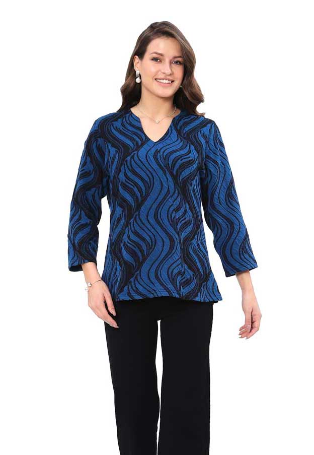 Woman wearing a blue patterned top on a white background