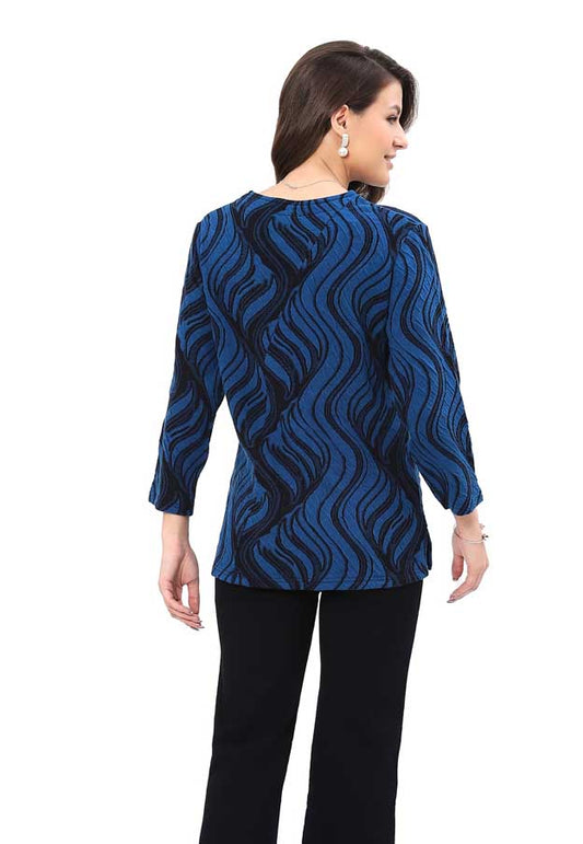 Woman wearing a blue patterned top on a white background