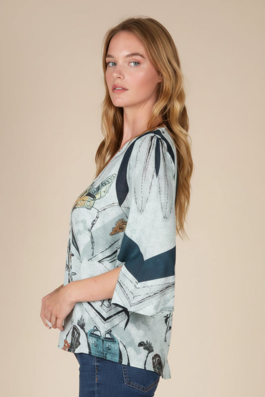 Woman wearing a patterned blouse with a neutral background
