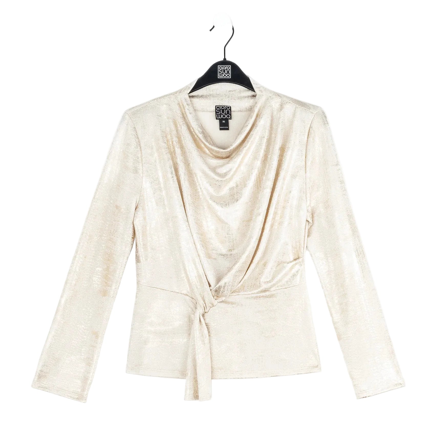 Beige long-sleeve top on a hanger with a white background
