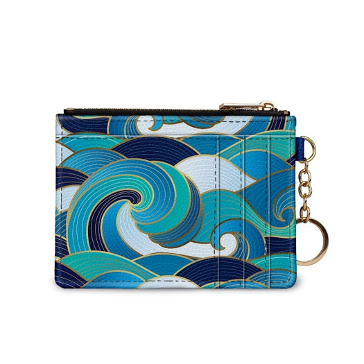 RFID Credit Card Wallet  with zipper pouch and gold tone key chain. Navy, green, blue, and white waves print on vegan leather. Size 5 inches by 3 1/4 inches