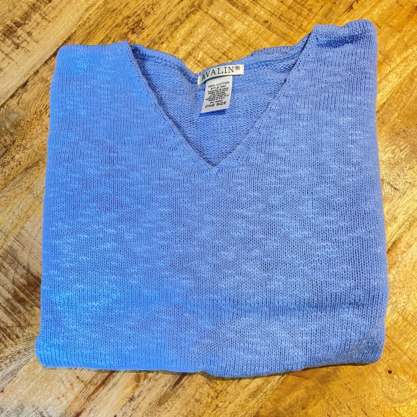 100% cotton slub sweater by Avalin. In color periwinkle blue with long sleeves, v-neck,  straight hem with ribbed edges. Semi-crop style falls just below the belt. Made in USA.