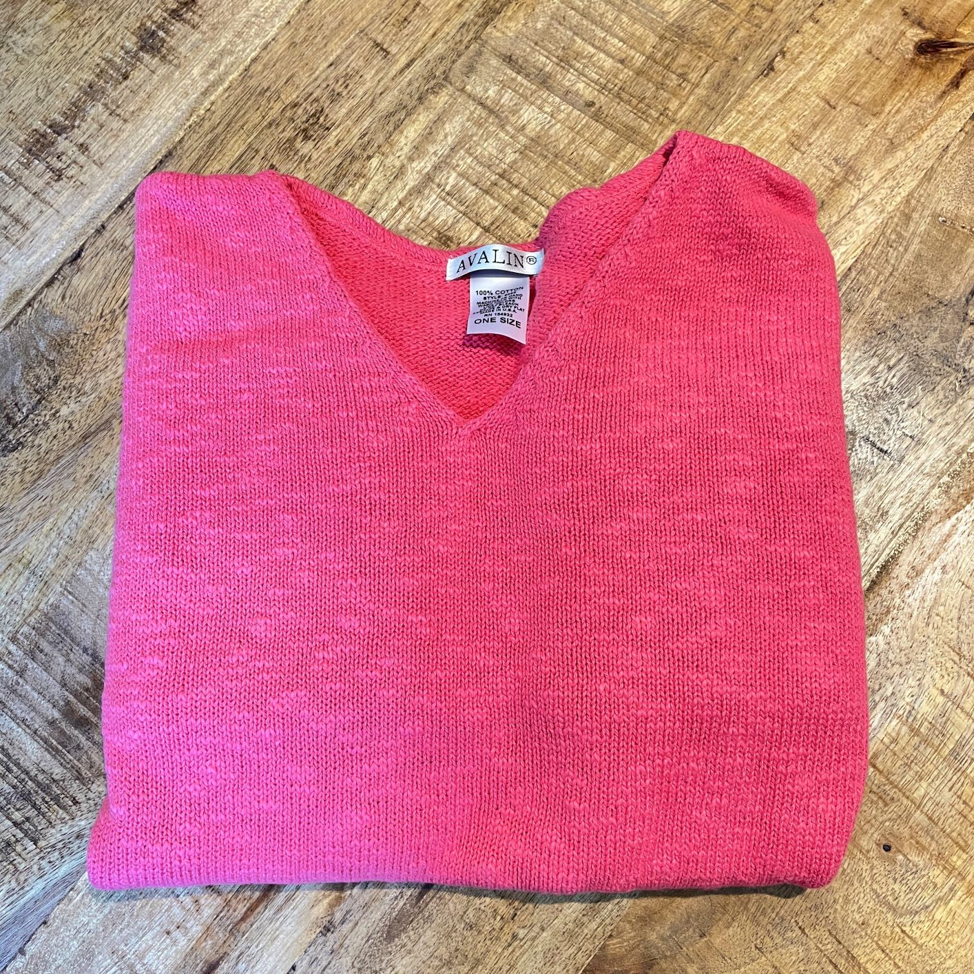 100% cotton slub sweater by Avalin. In color Coral with long sleeves, v-neck,  straight hem with ribbed edges. Semi-crop style falls just below the belt. Made in USA.