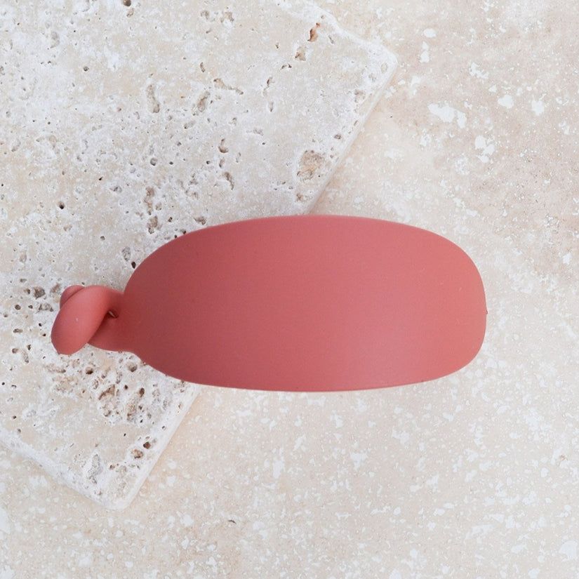 This hair clip is crafted from 100% acrylic and features a unique egg shape and matte finish. Measuring in at 2" x 1" x 1", this clip is secured with a twist closure.