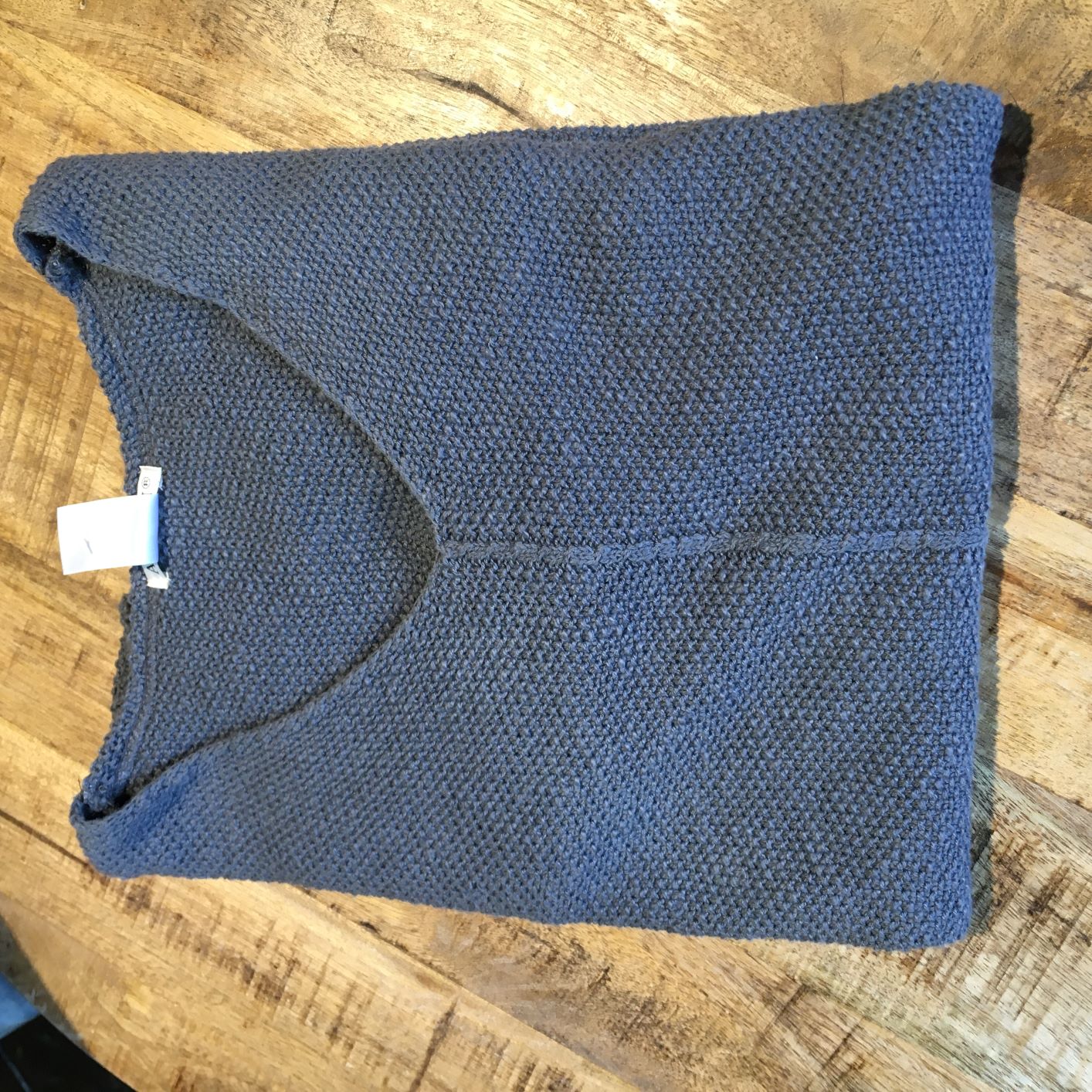100% cotton slub seed stitch sweater by Avalin. In color Charcoal with long sleeves, v-neck, center seam, ribbed cuffs and ribbed straight hem with side slits. Falls just below mid hip.  Made in USA.