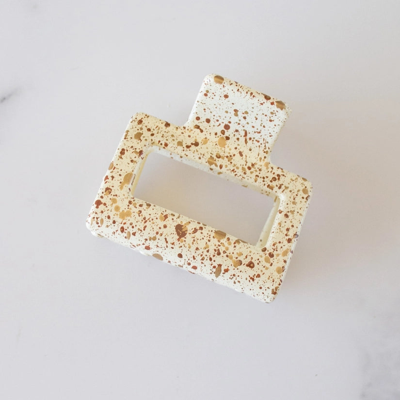 This 2-inch Acrylic Clip is speckled with vibrant colors and features a rectangular shape, allowing it to easily hold fine or pull back a section of hair.