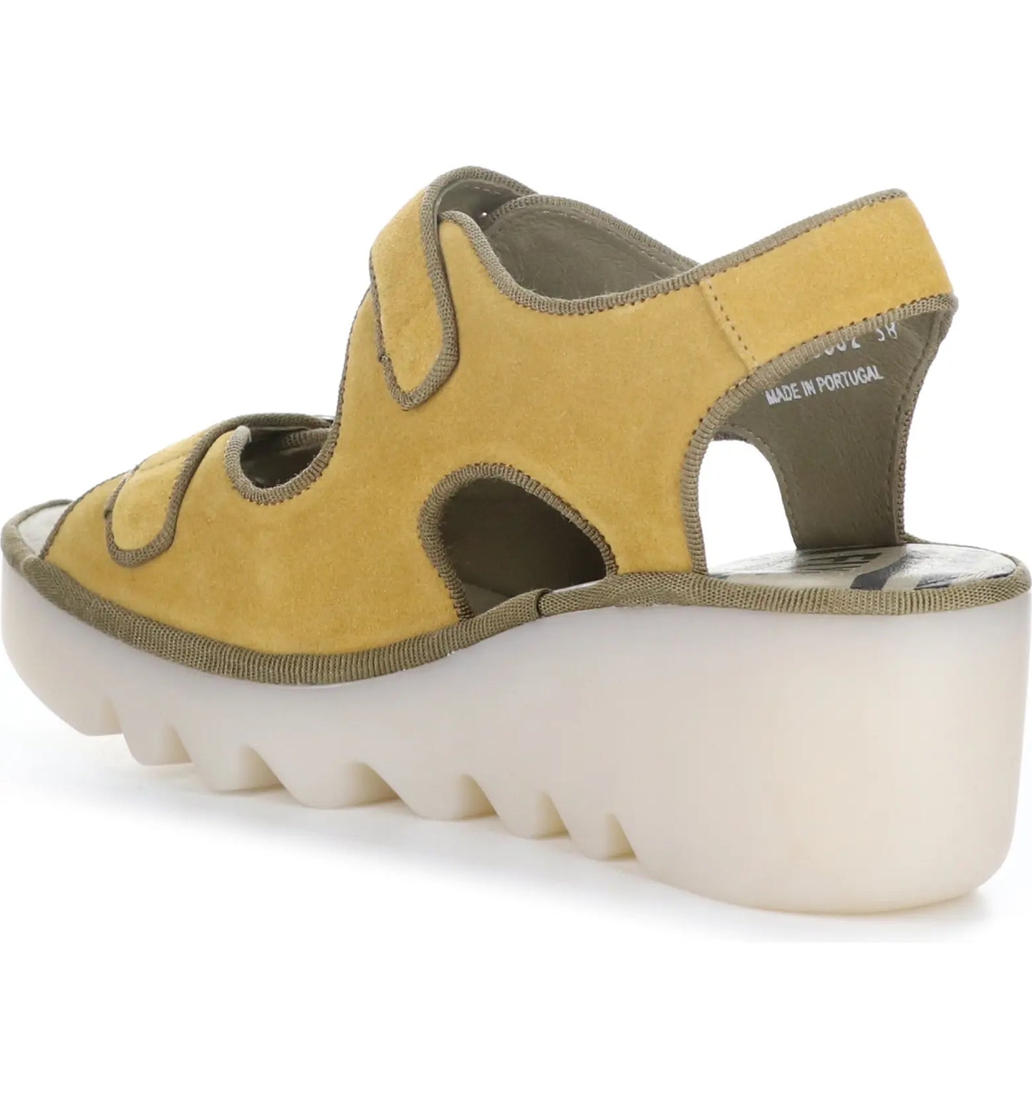 Fly London golden honey suede leather upper sandal features a hook and loop adjustable upper strap (buckle adjusts too) and a buckle lower strap. On a 3 inch shock absorbing wedge sole.  Made in Portugal