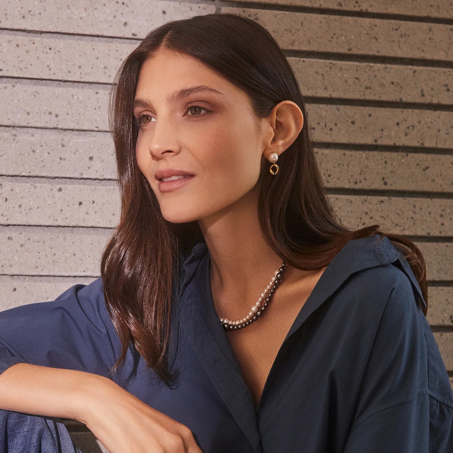 The Lou Pearl earrings are a classic accessory with modern appeal. Crafted from 18k gold plated brass with a white shell pearl, these earrings are designed by California-based designer Gorjana for a timeless look. Perfect for any occasion.