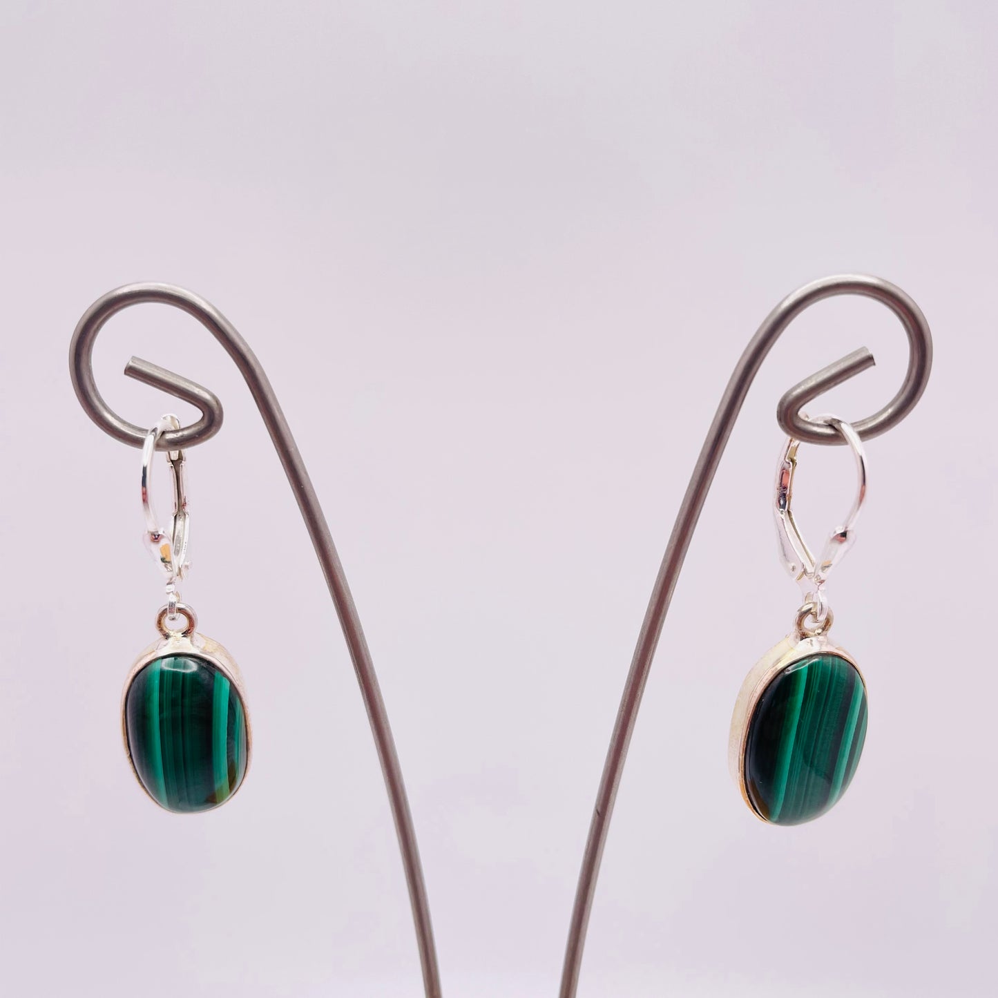 Small oval genuine malachite  set in 925 Sterling Silver. Lever back ear wires.