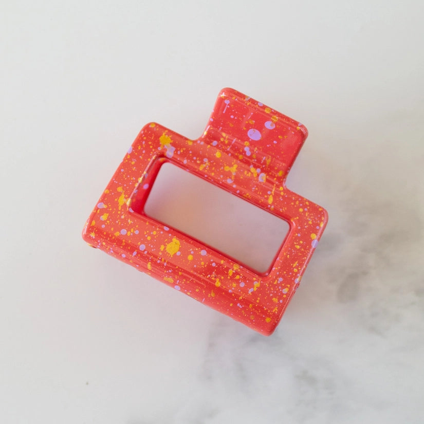 This 2-inch Acrylic Clip is speckled with vibrant colors and features a rectangular shape, allowing it to easily hold fine or pull back a section of hair.