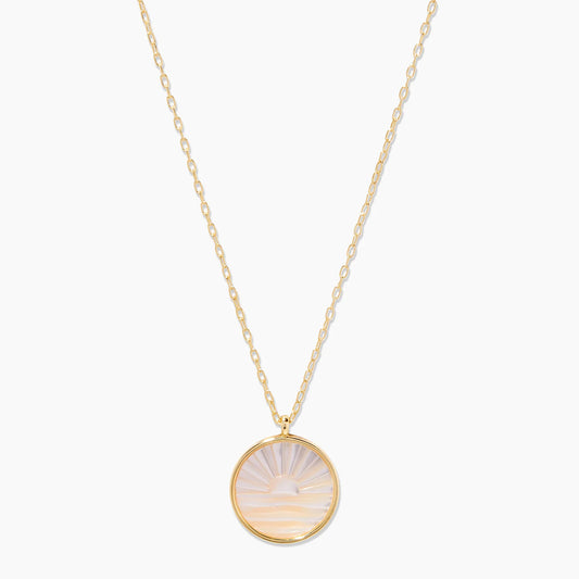 The Sunset Etched Pendant from Gorjana is an 18k gold plated brass piece with a stunning etched Mother of Pearl pendant. The adjustable chain allows for a perfect and comfortable fit for any wearer. With this pendant, you won't ever miss a beautiful sunset again.