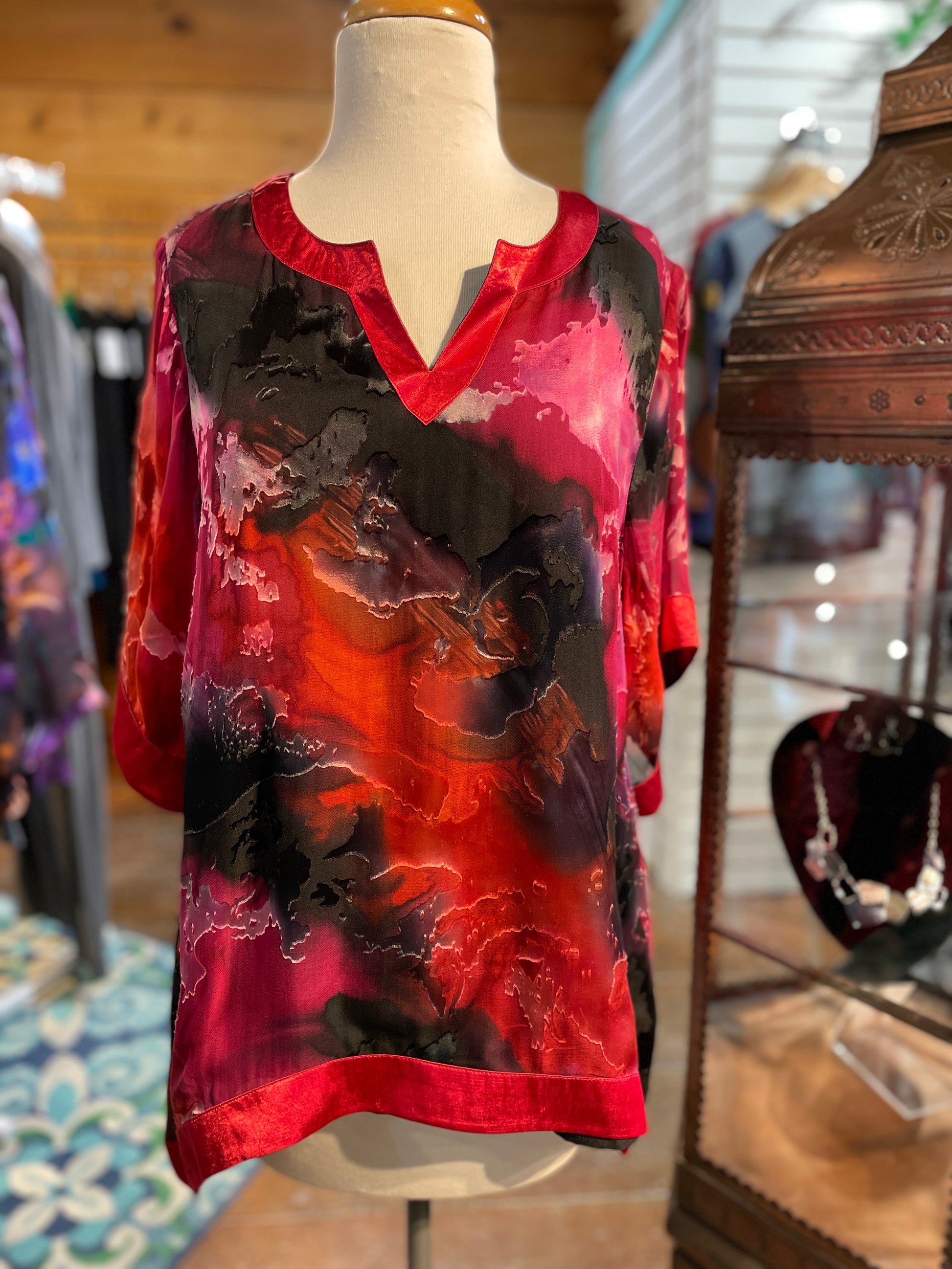 Hand-panted Hi-Lo Top. Stunning hand-painted silk, short sleeve, hi-low hem top with silk edging and polyester lining.  100% Silk | Dry Clean | Imported.