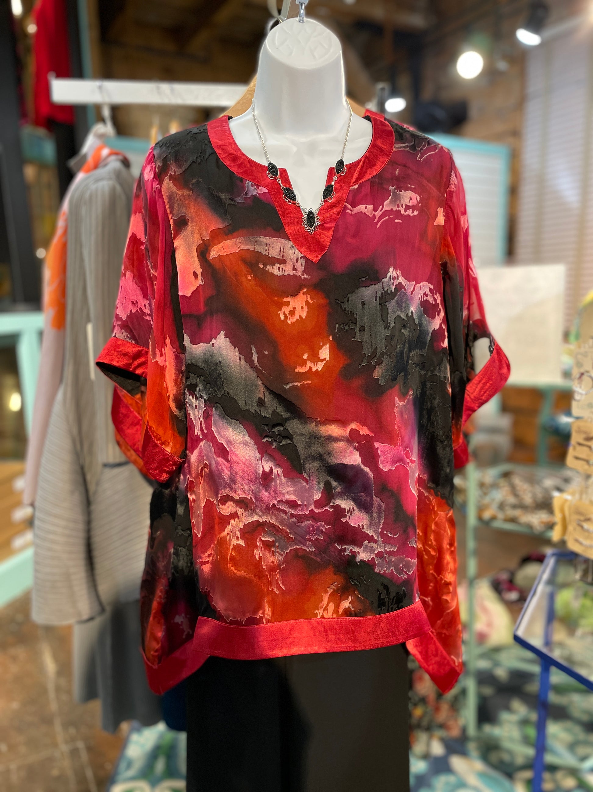 Hand-panted Hi-Lo Top. Stunning hand-painted silk, short sleeve, hi-low hem top with silk edging and polyester lining. 100% Silk | Dry Clean | Imported.